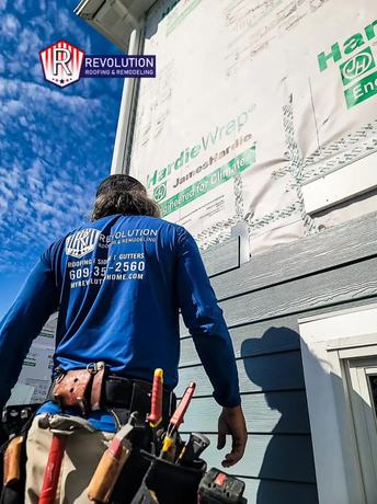 Revolution crew installing siding and protective house wrap