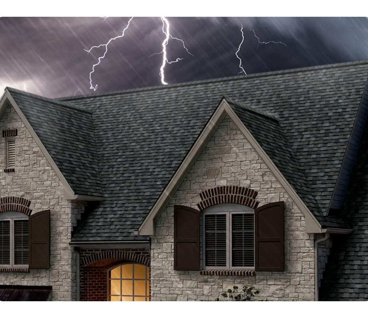 Home exterior with lightning striking in a dark storm sky behind it