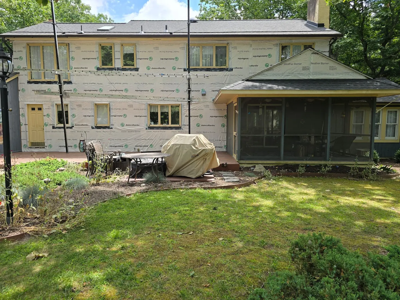 A home fully wrapped in James Hardie weather barrier, ready for new siding to go on